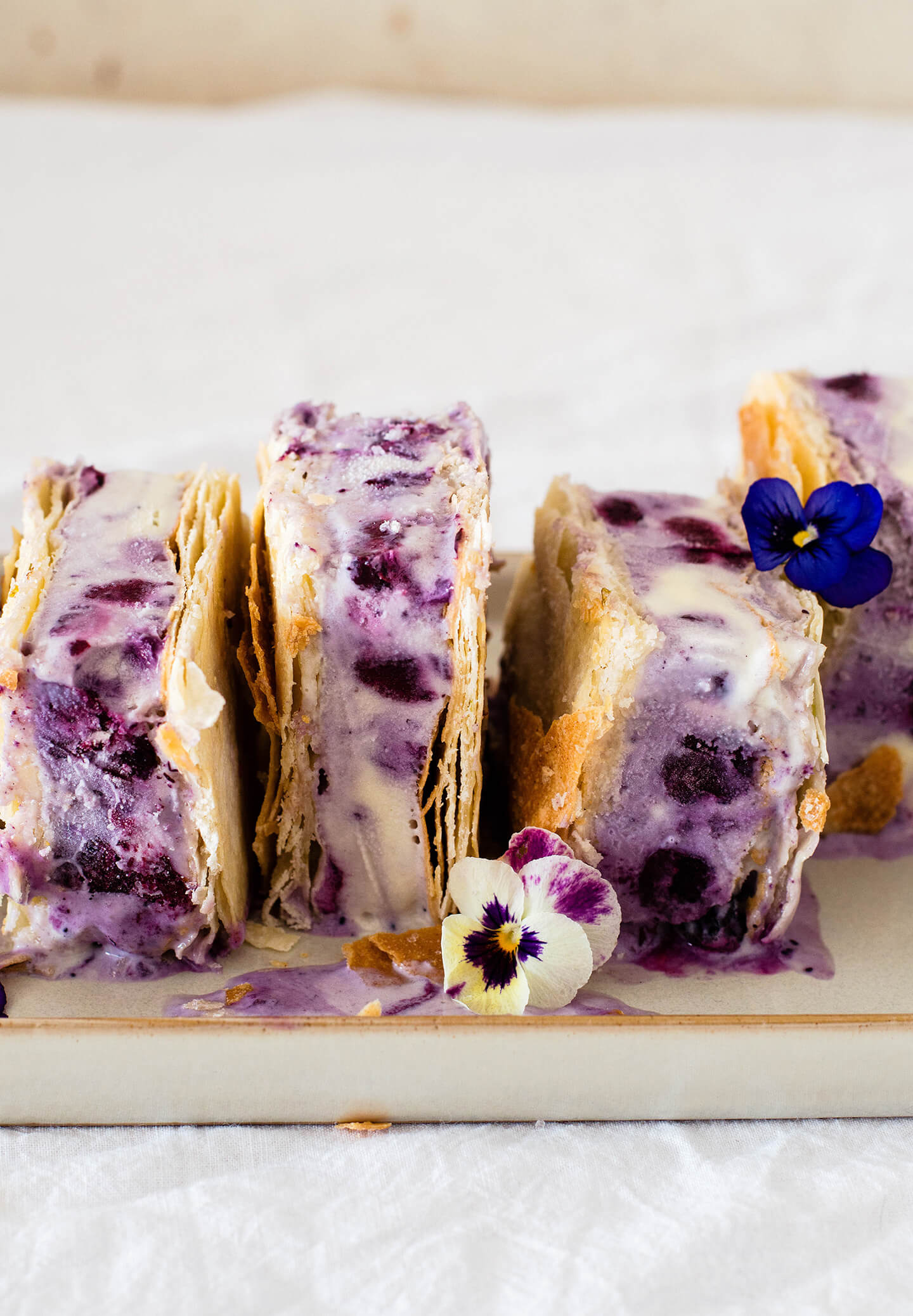 Roasted blueberry phyllo ice cream sandwiches are the perfect summer treat! Pretty to look at and tasty, filled with berries and lime sugar! 