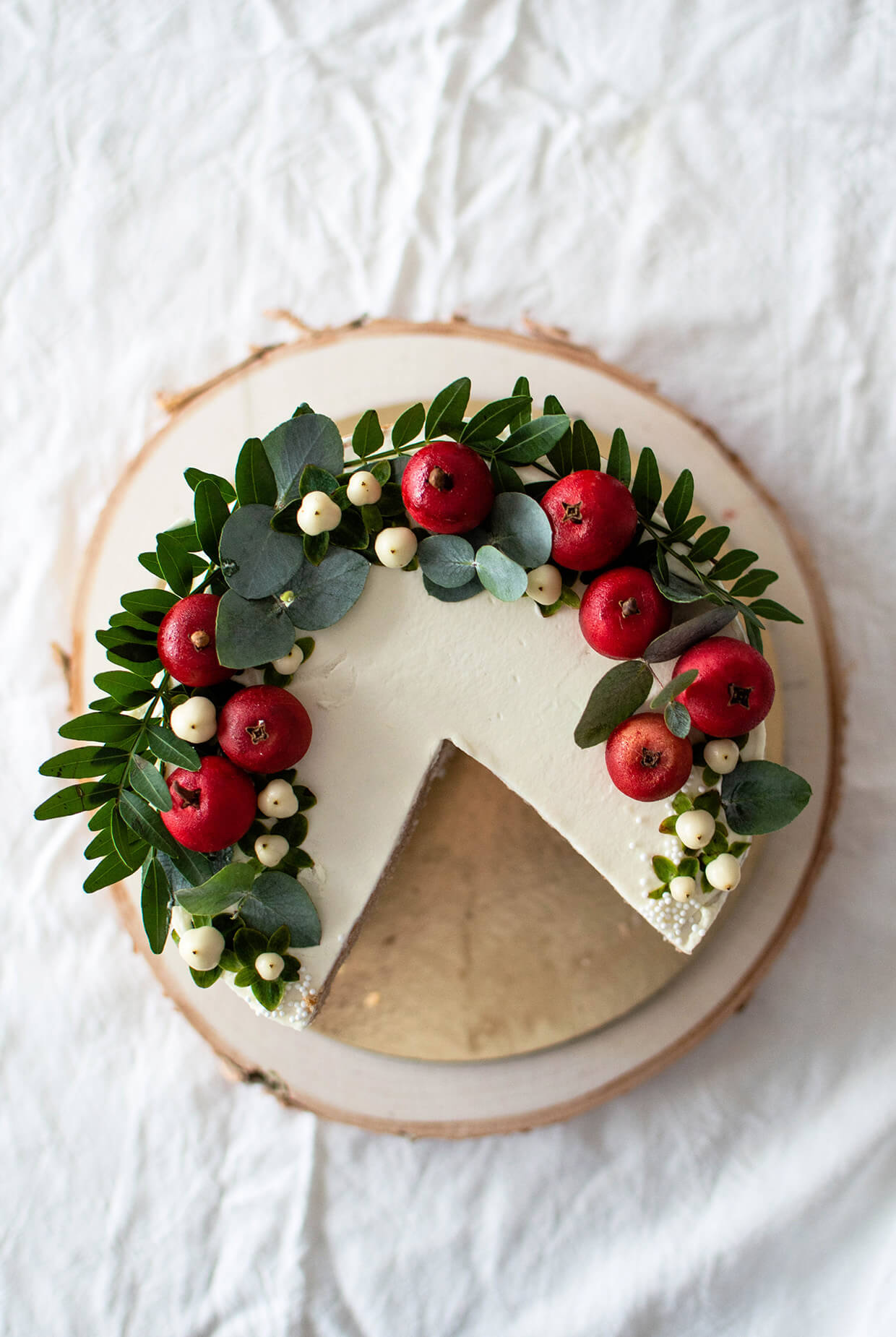 top view of apple layer cake, decorated with greens and mini apples