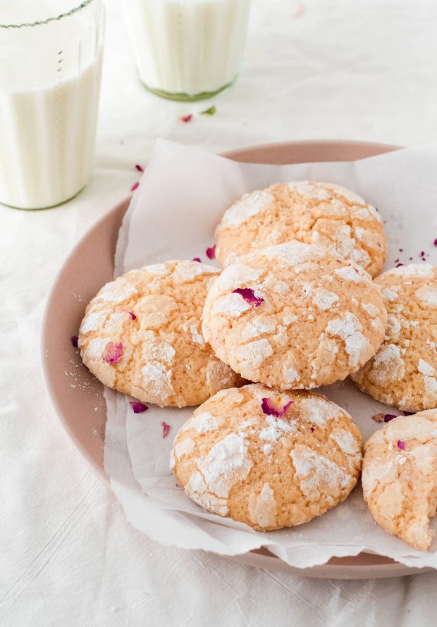 rose water lemon crinkle cookies on pink plate with milk