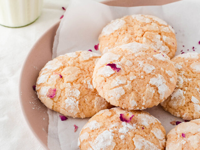 rose water lemon crinkle cookies on pink plate with milk