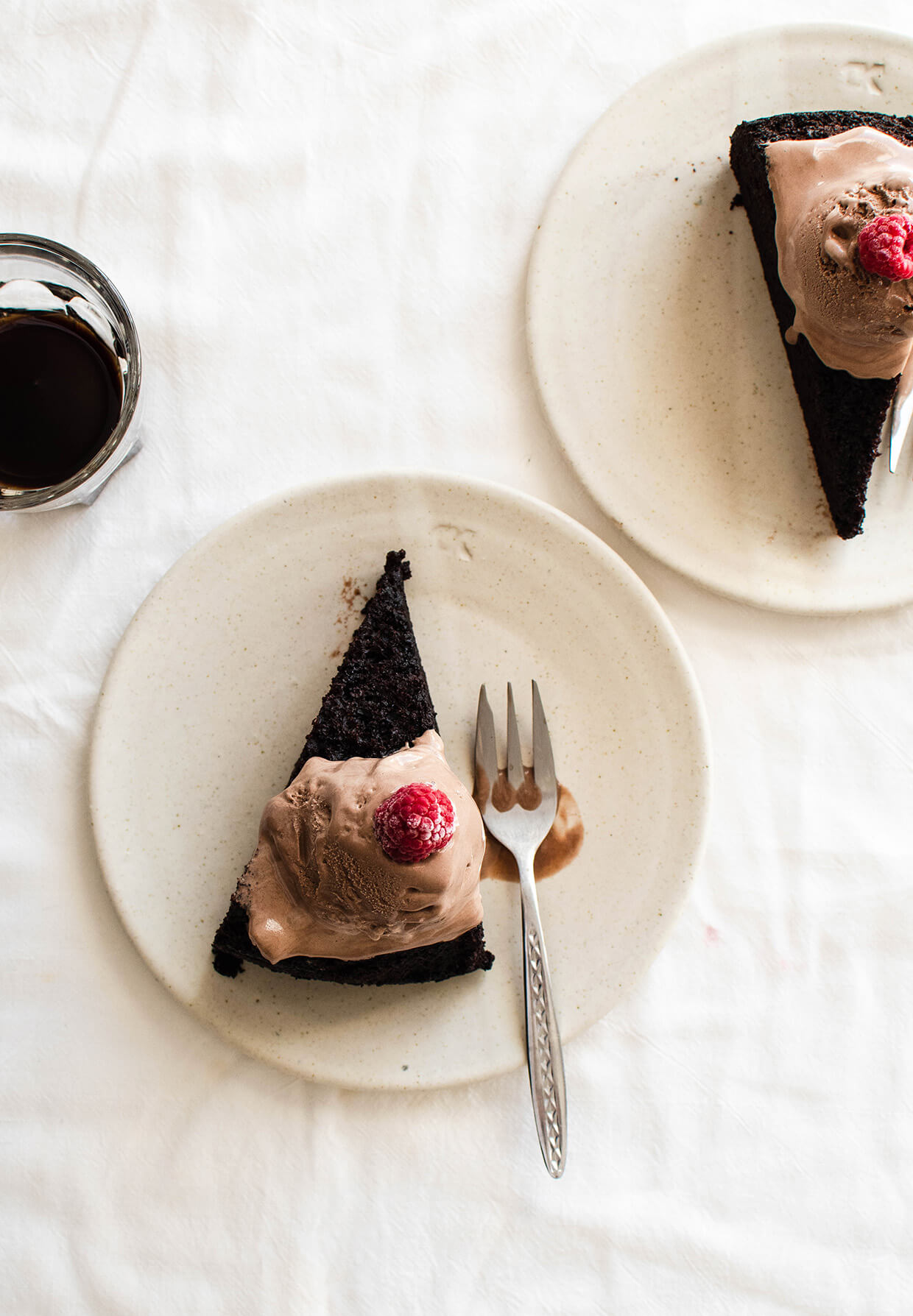 Pictured slices of chocolate cake with ice cream on plates (one chocolate cake - three ways to serve, learn how to transform one chocolate stout cake into something new each time you make it. )