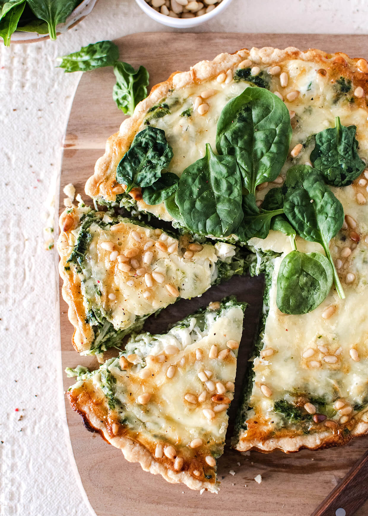 leek spinach tart with cheese and pine nuts, sliced