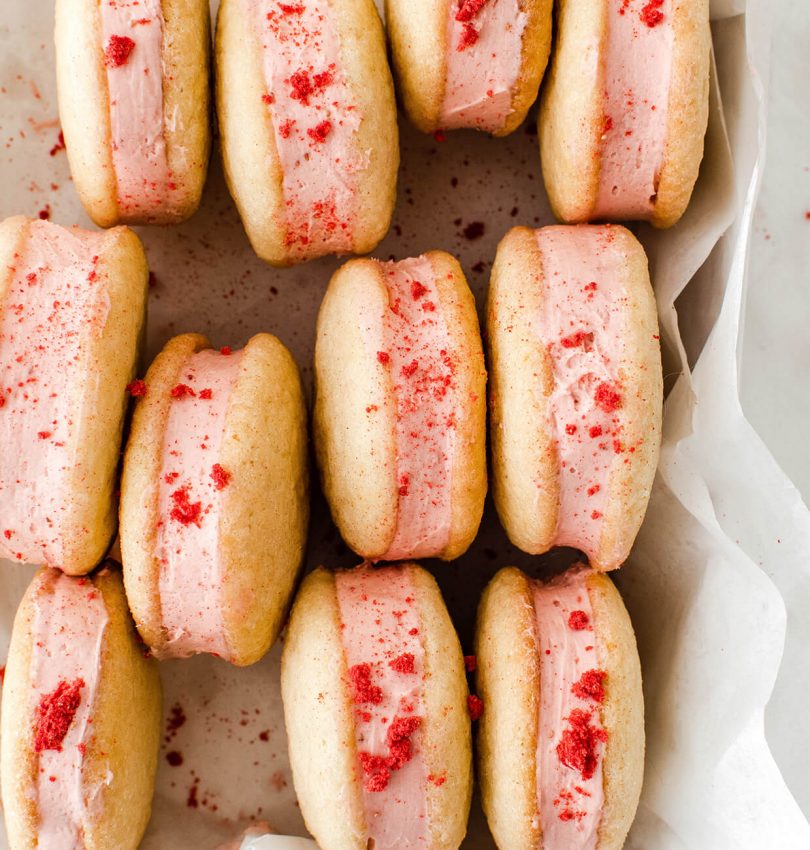 lemon strawberry cheesecake sandwich cookies are easy to make and are beyond delicious! made with tub cream cheese and freeze dried strawberries, they can be a year-round recipe, great for parties, birthdays and holidays!