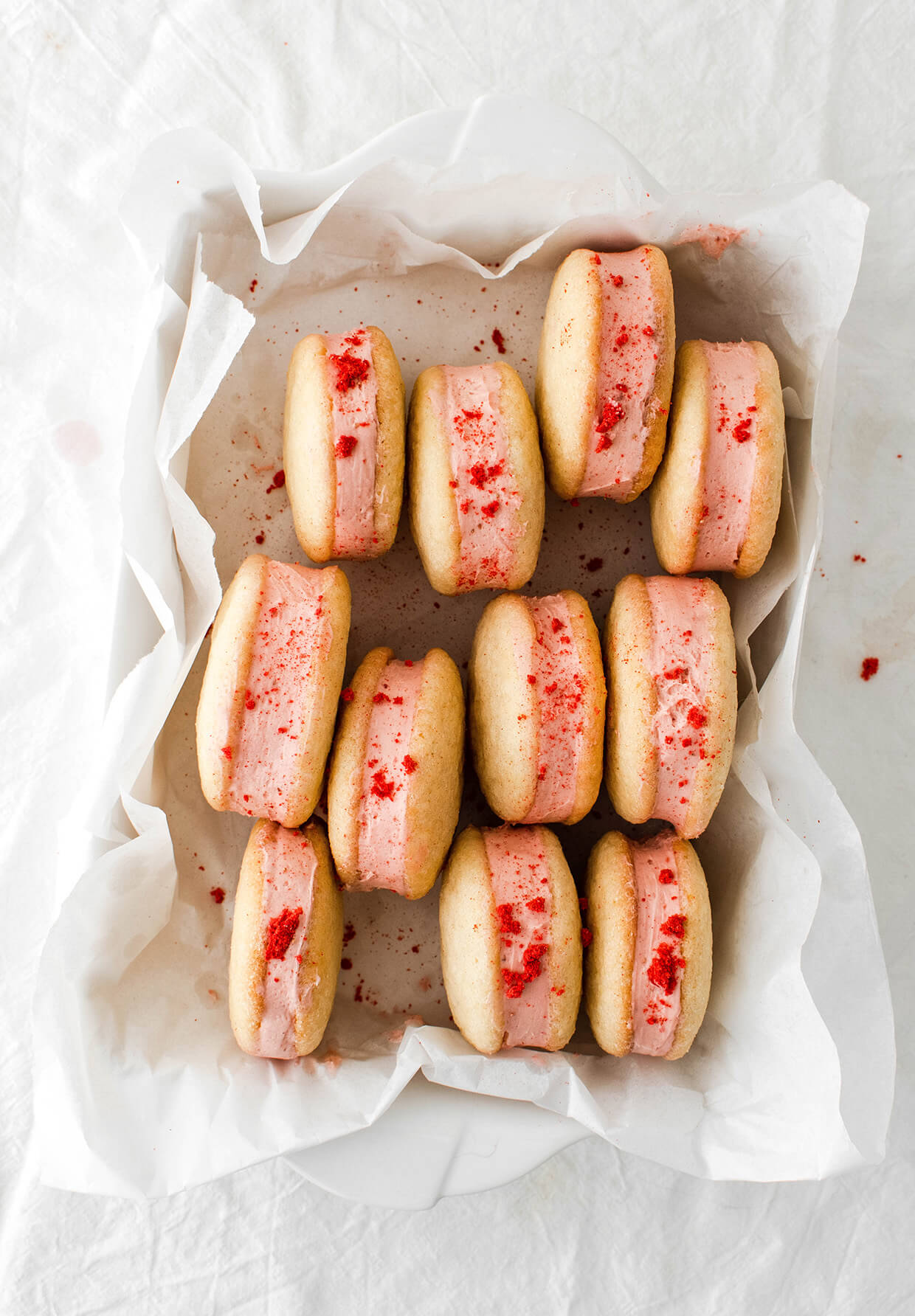 white tray of pink strawberry sandwich cookies