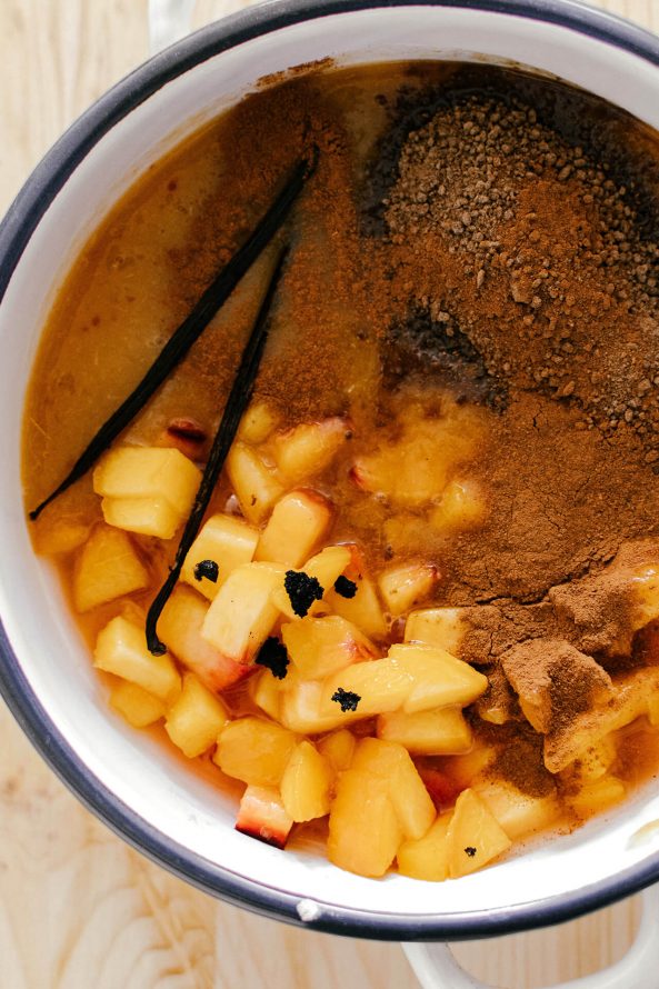 chopped peaches with sugar and vanilla in a bowl to make fresh peach sauce