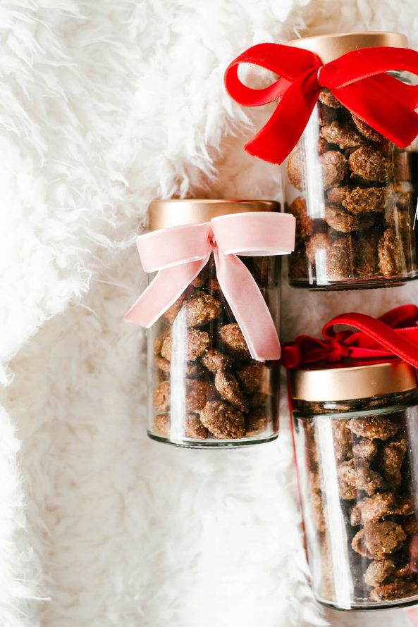glass jars with velvet ribbon filled with roasted almonds for the holidays