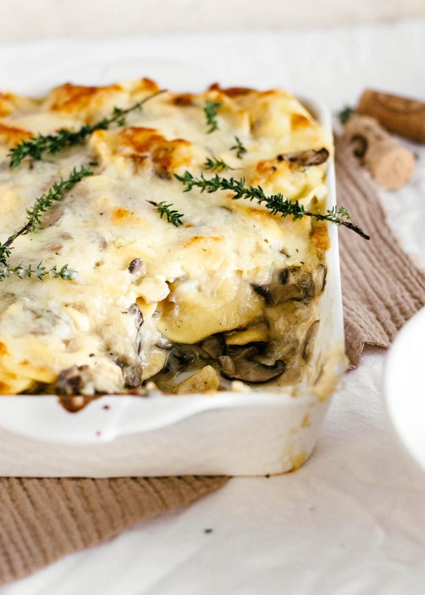 easy cheesy mushroom baked ravioli in a serving dish