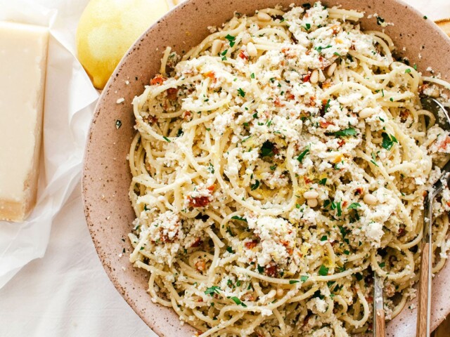 cooked pasta with pesto in large bowl