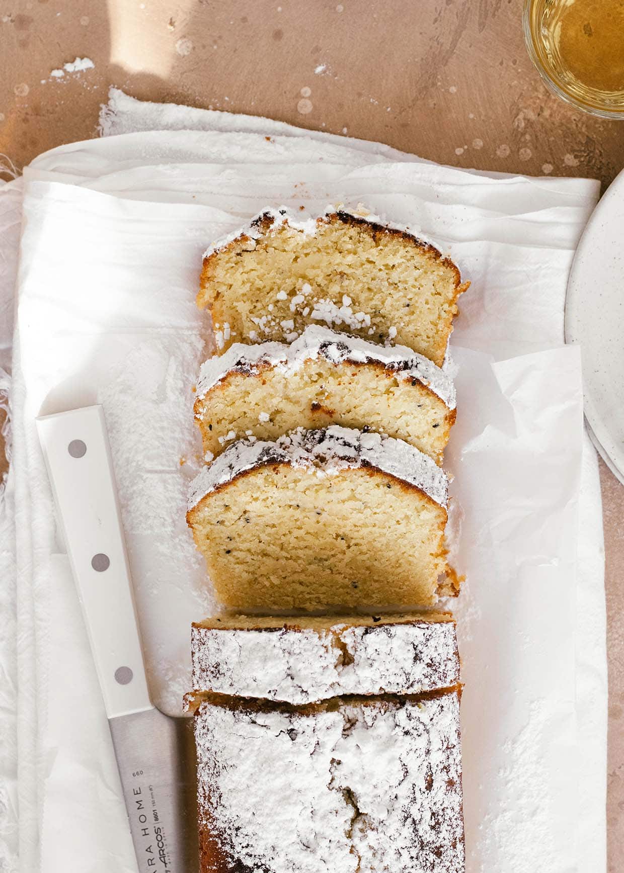 sliced kiwi lime loaf cake dusted with powdered sugar