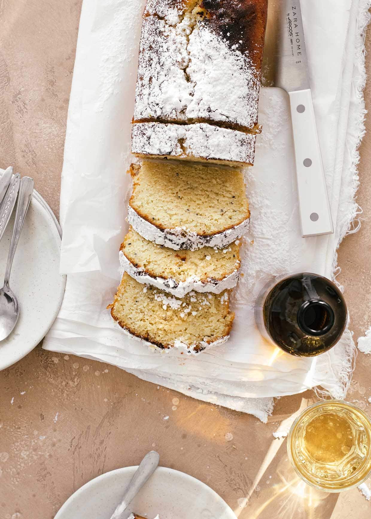 sliced kiwi lime loaf cake with yogurt and powdered sugar