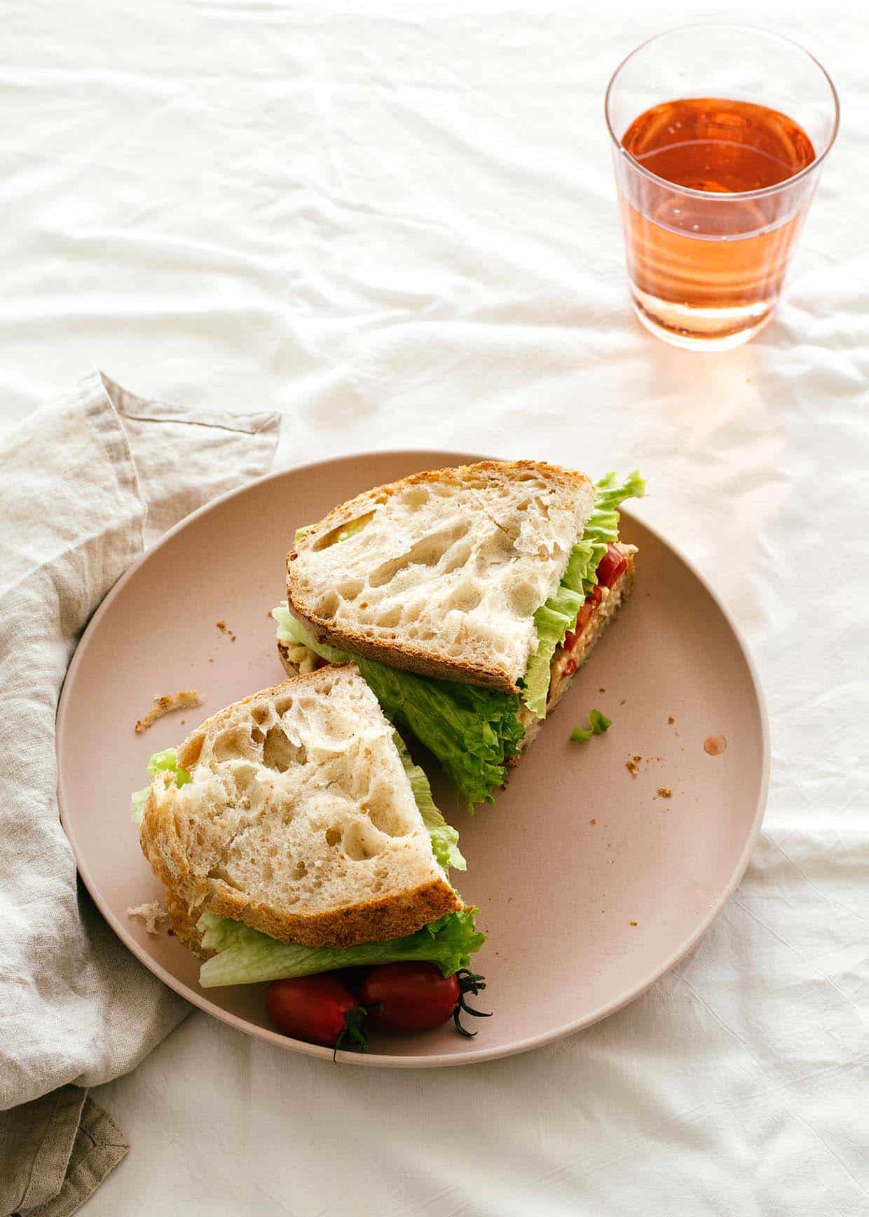 sourdough sandwich with chickpea tuna salad, lettuce and tomatoes