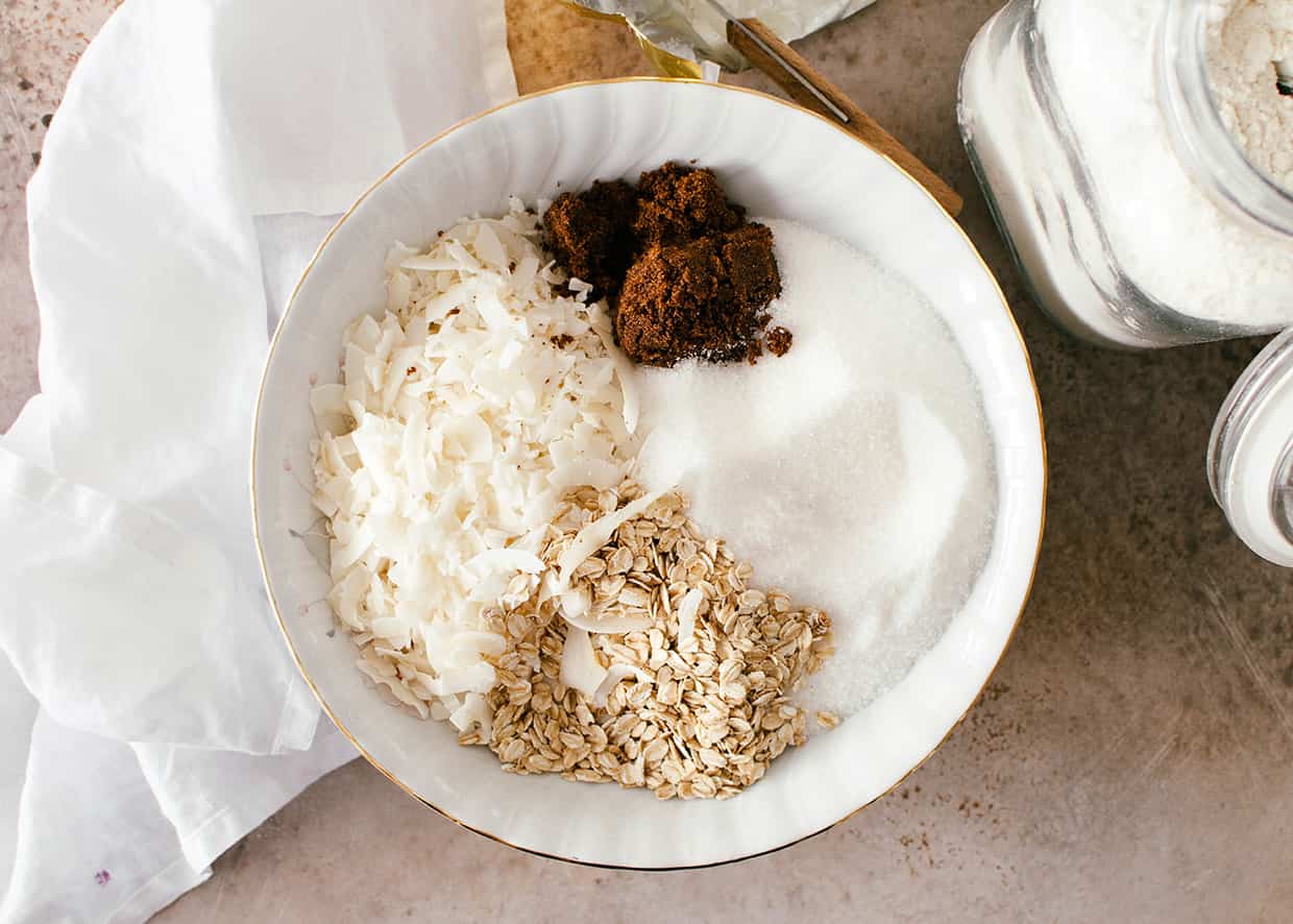 a deep plate with coconut flakes, oats, white and brown sugar