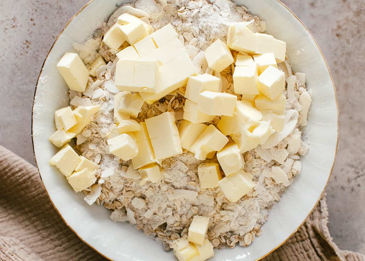 cubes of butter atop a mixture of oats and flour