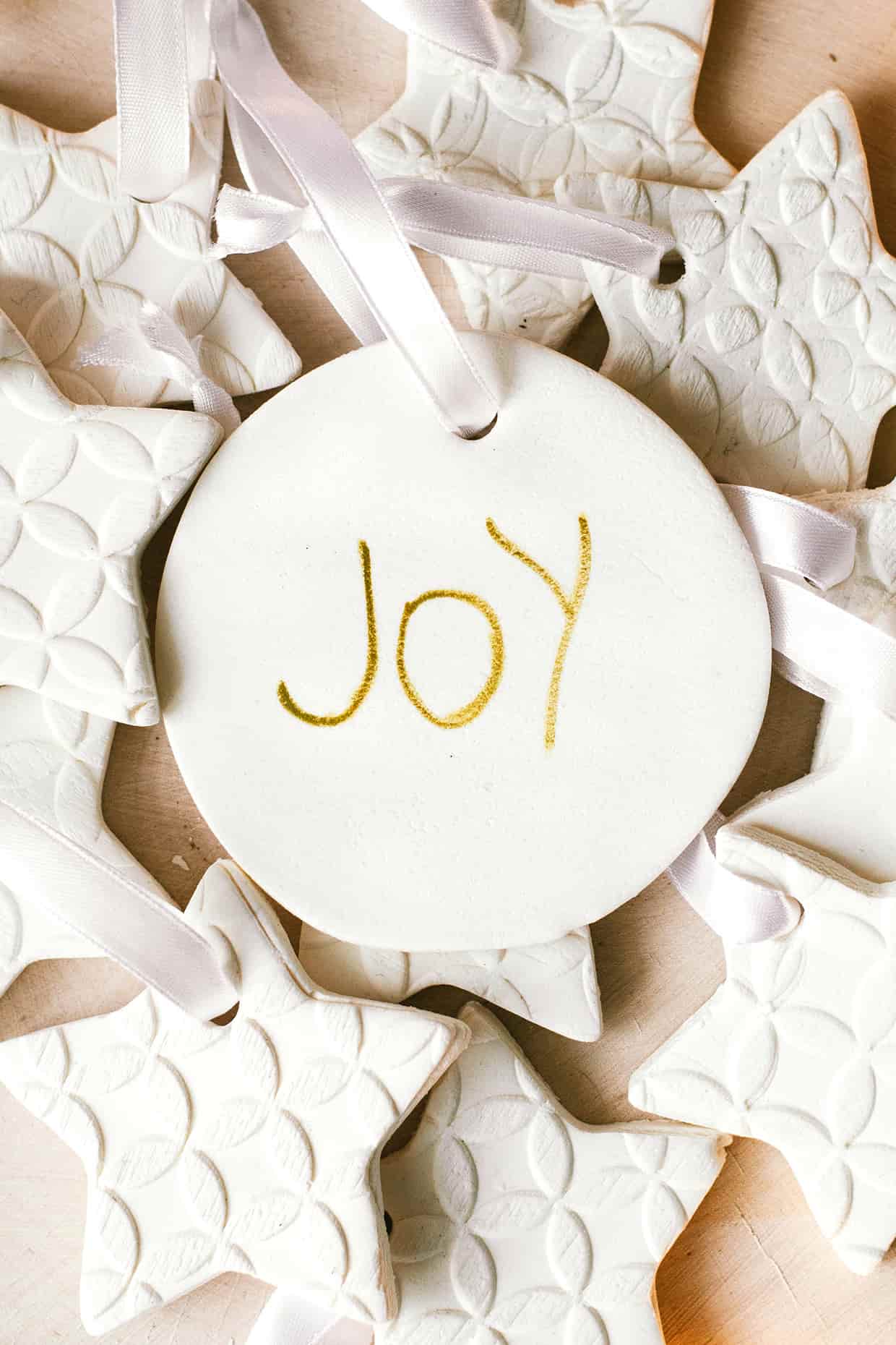 round white ornament with word joy on it
