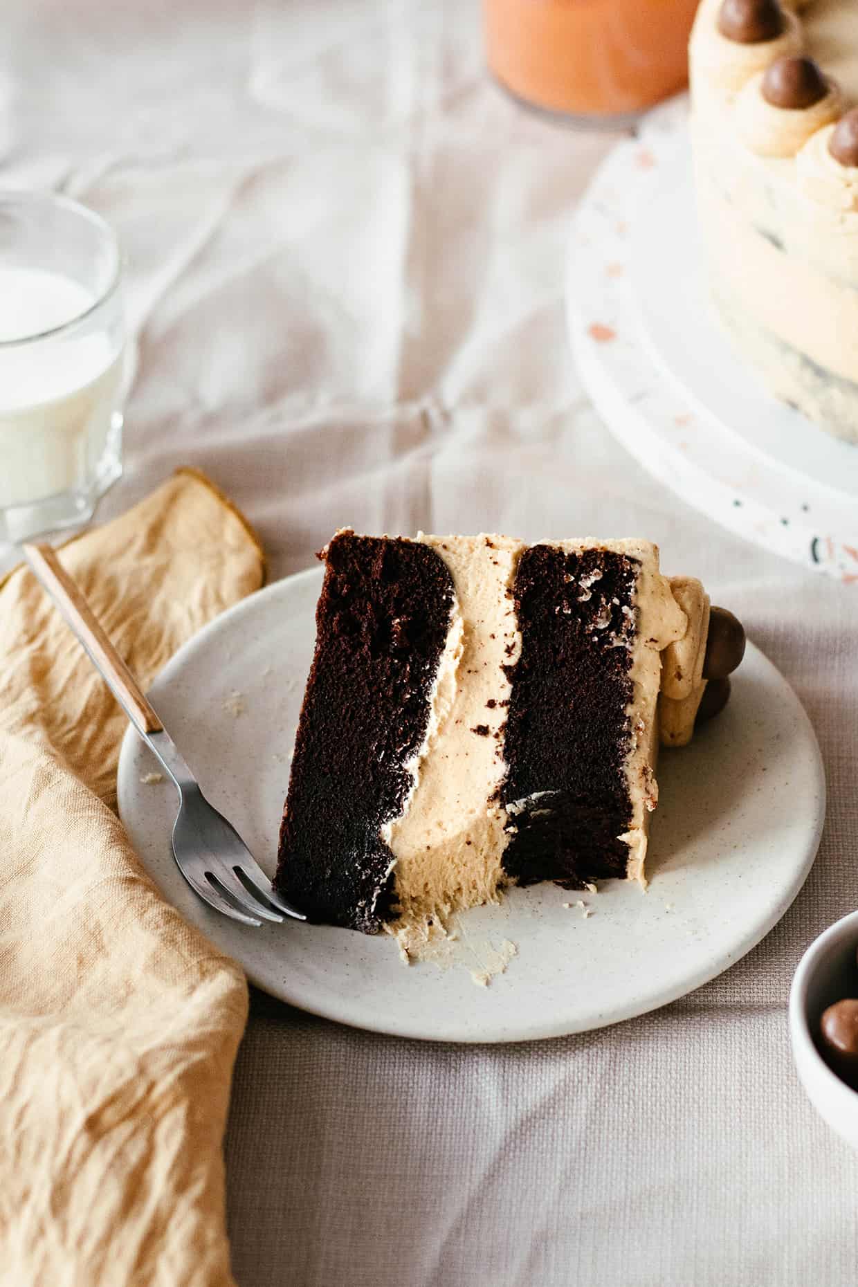 Slice of rich chocolate peanut butter cake on a plate