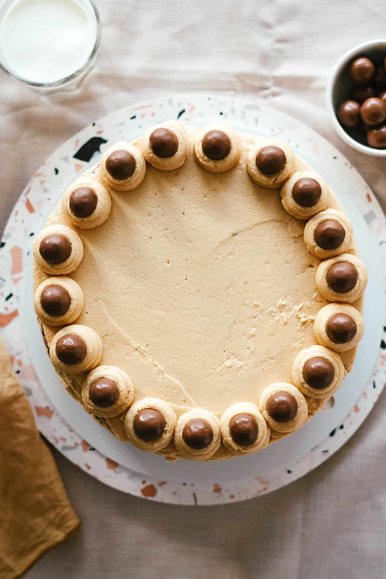 top view of peanut butter cake decorated with malt chocolate balls