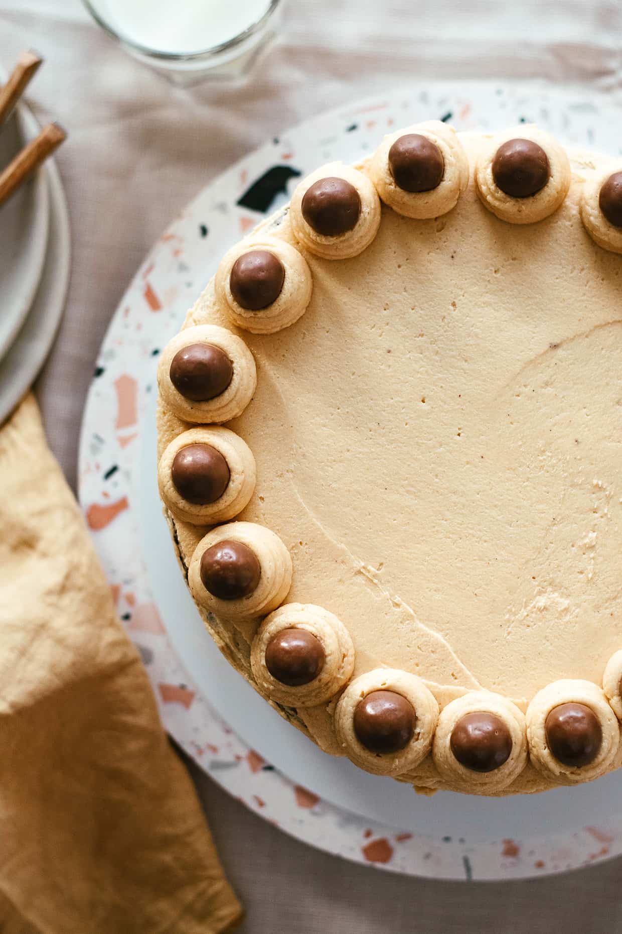 close view of peanut butter cake decorated with malt chocolate balls