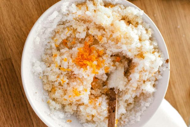 a mix of sugar, coconut oil and orange zest in a bowl