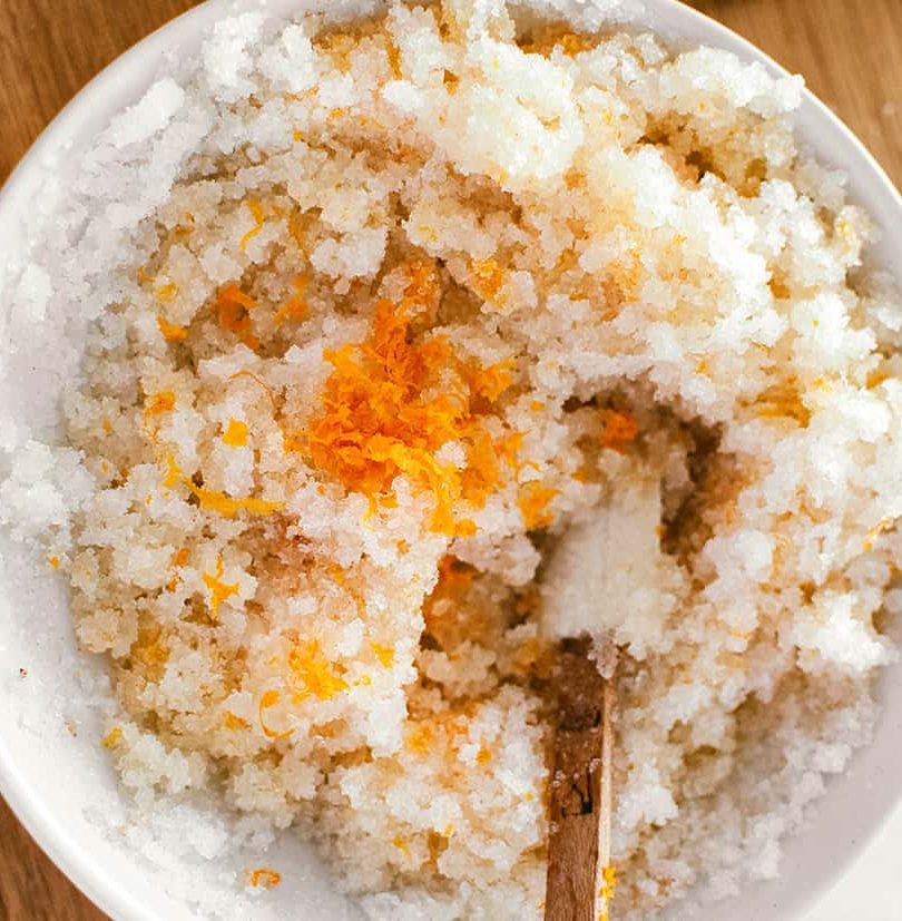 a mix of sugar, coconut oil and orange zest in a bowl