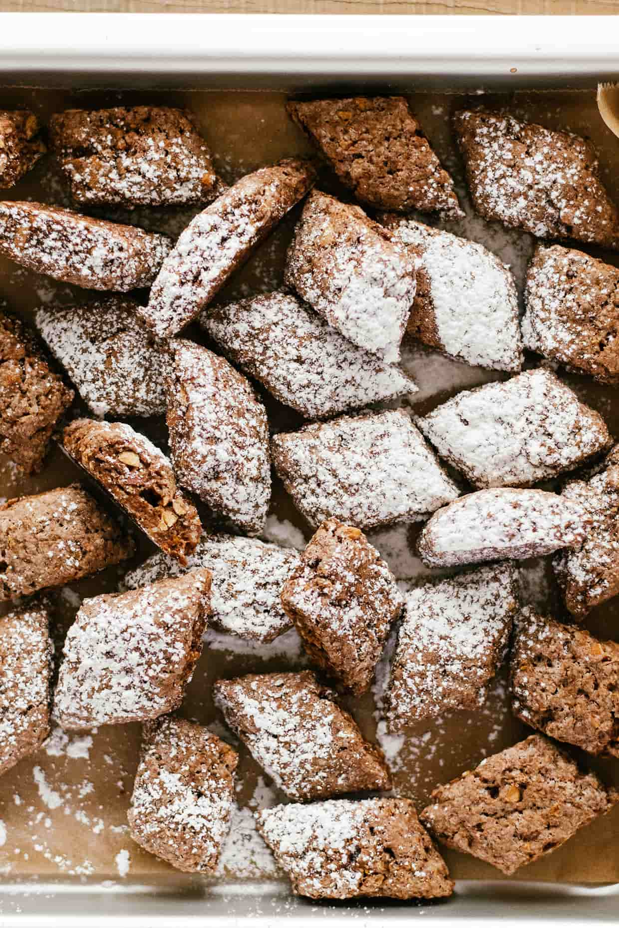 cocoa cookies tossed on a baking sheet and sprinkled with powdered sugar