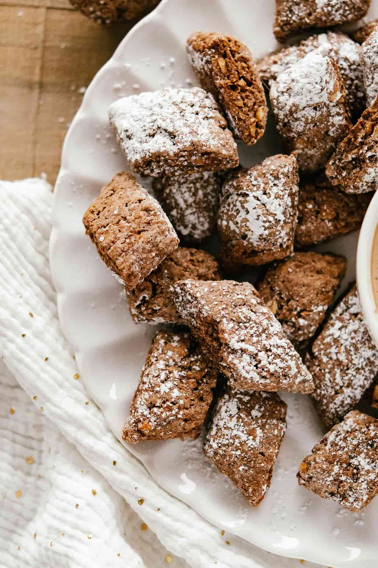 close view of rectangular cocoa cookies dusted with sugar on a plate