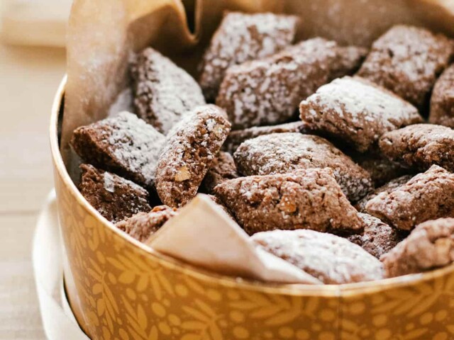 brown cookies dusted with sugar in a cookie tin