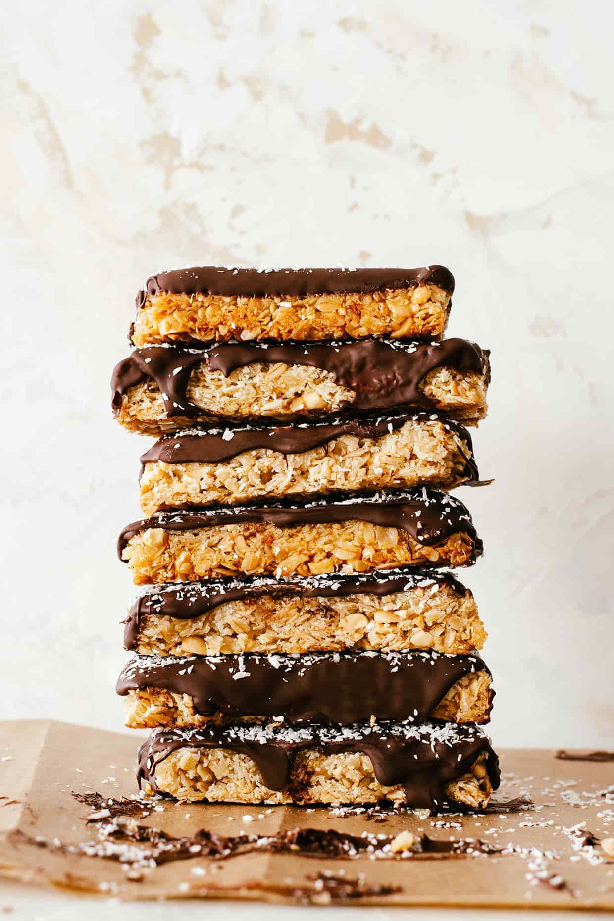 chocolate dipped coconut peanut granola bars stacked on top of each other
