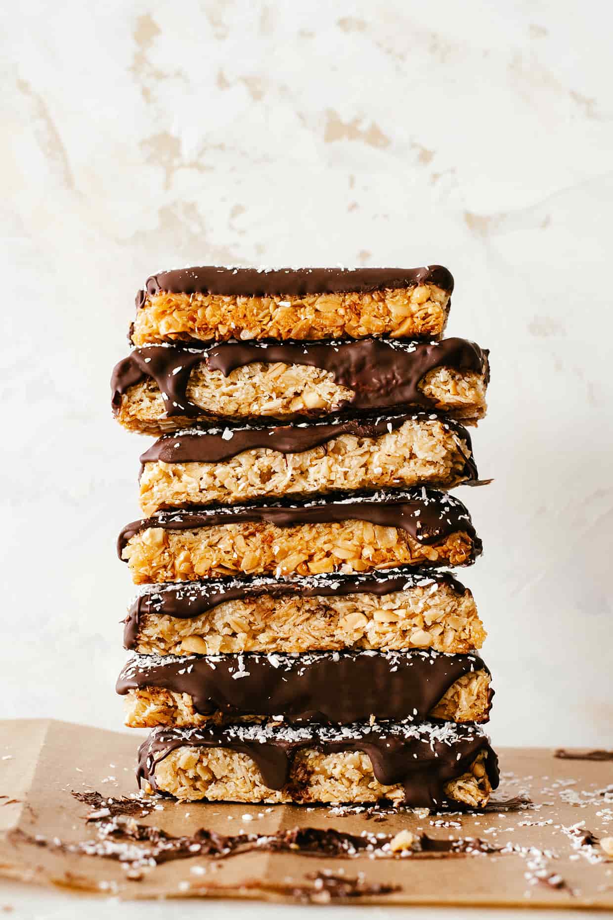 chocolate dipped coconut peanut granola bars stacked on top of each other