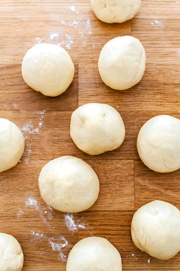 raw balls of dough on a wooden table 