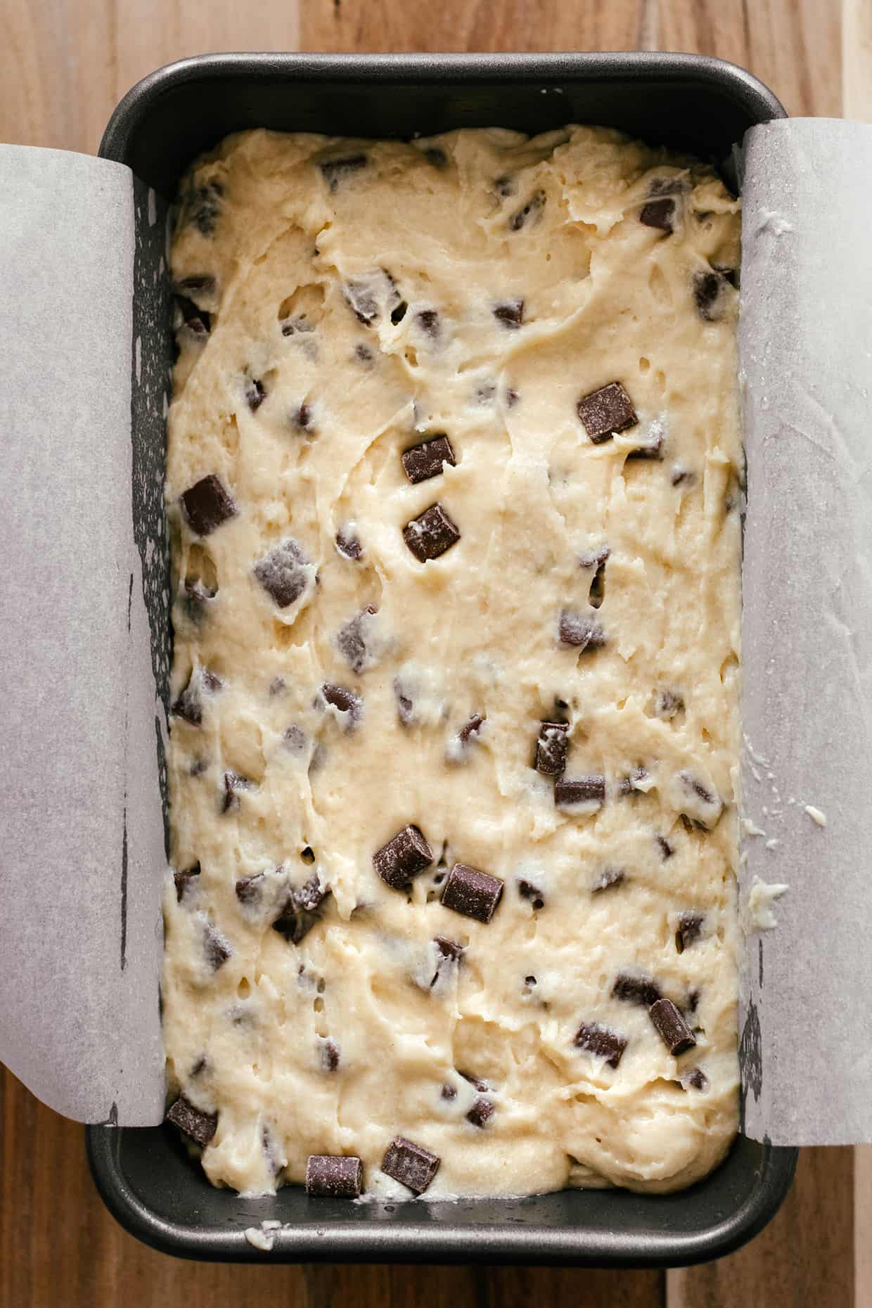 raw chocolate chip cake batter in a pan