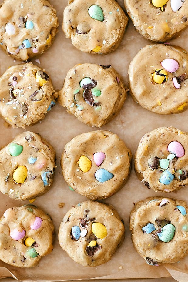 raw mini egg chocolate chip cookies placed on a cookie sheet