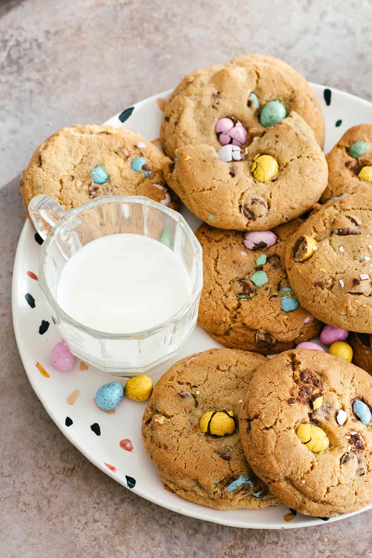 plate with easter egg cookies and glass of milk