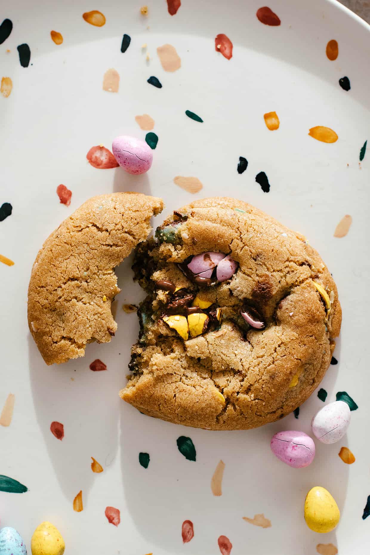 single mini egg chocolate cookie broken on a plate