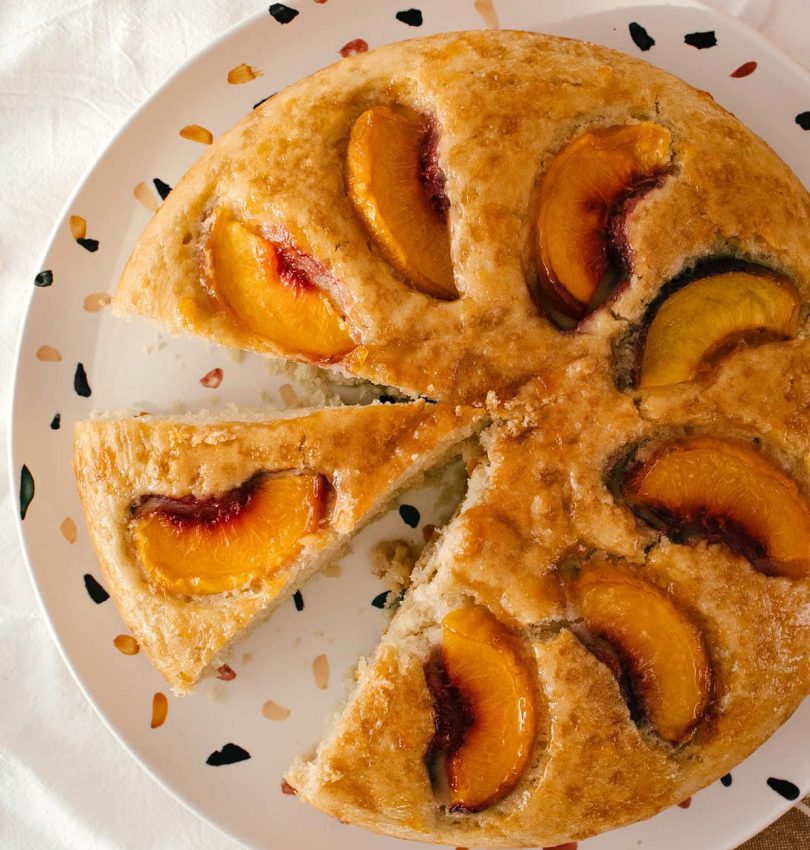 sliced peach cake on a plate