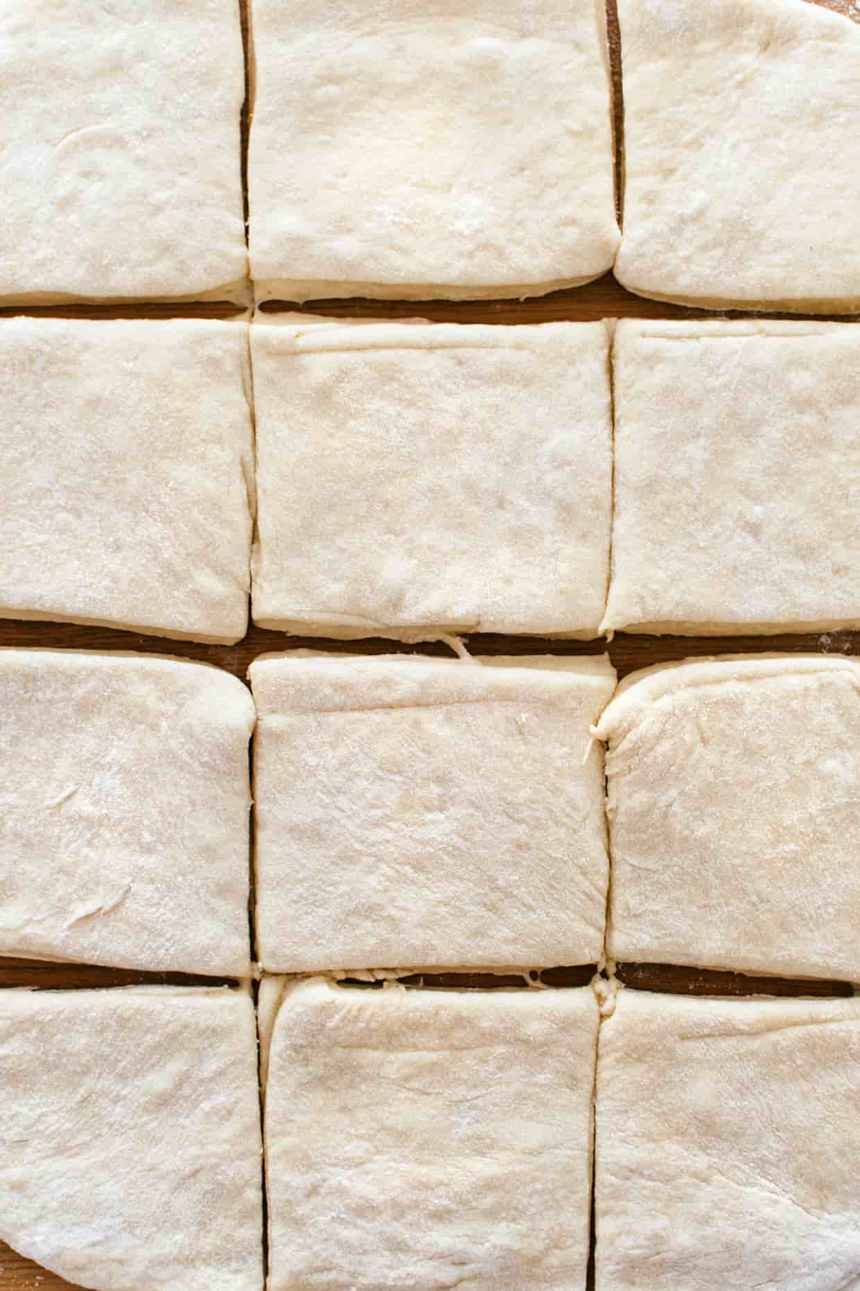 close view of rolled out yeast dough, sliced into squares