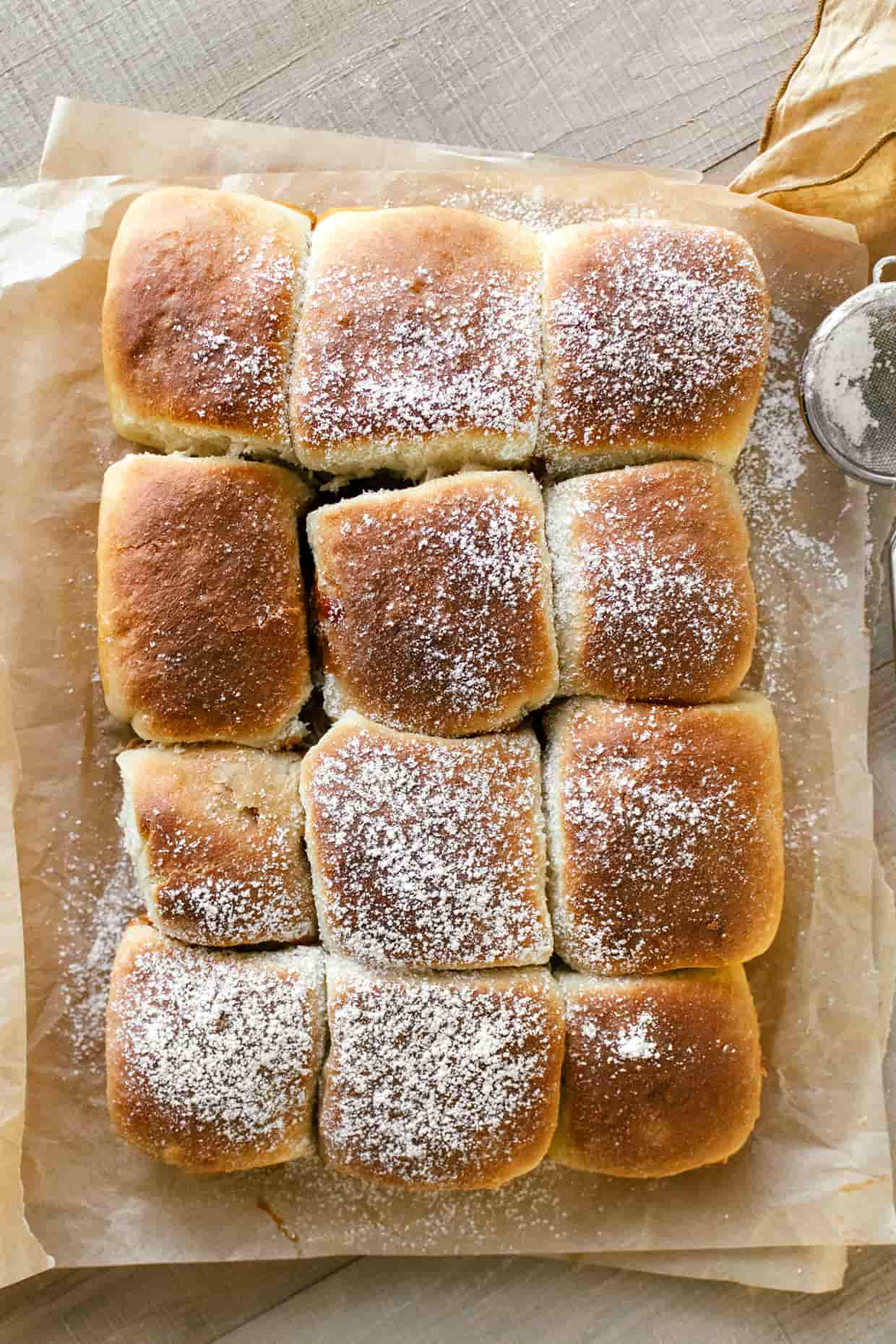 top view of baked bread rolls, dusted with sugar