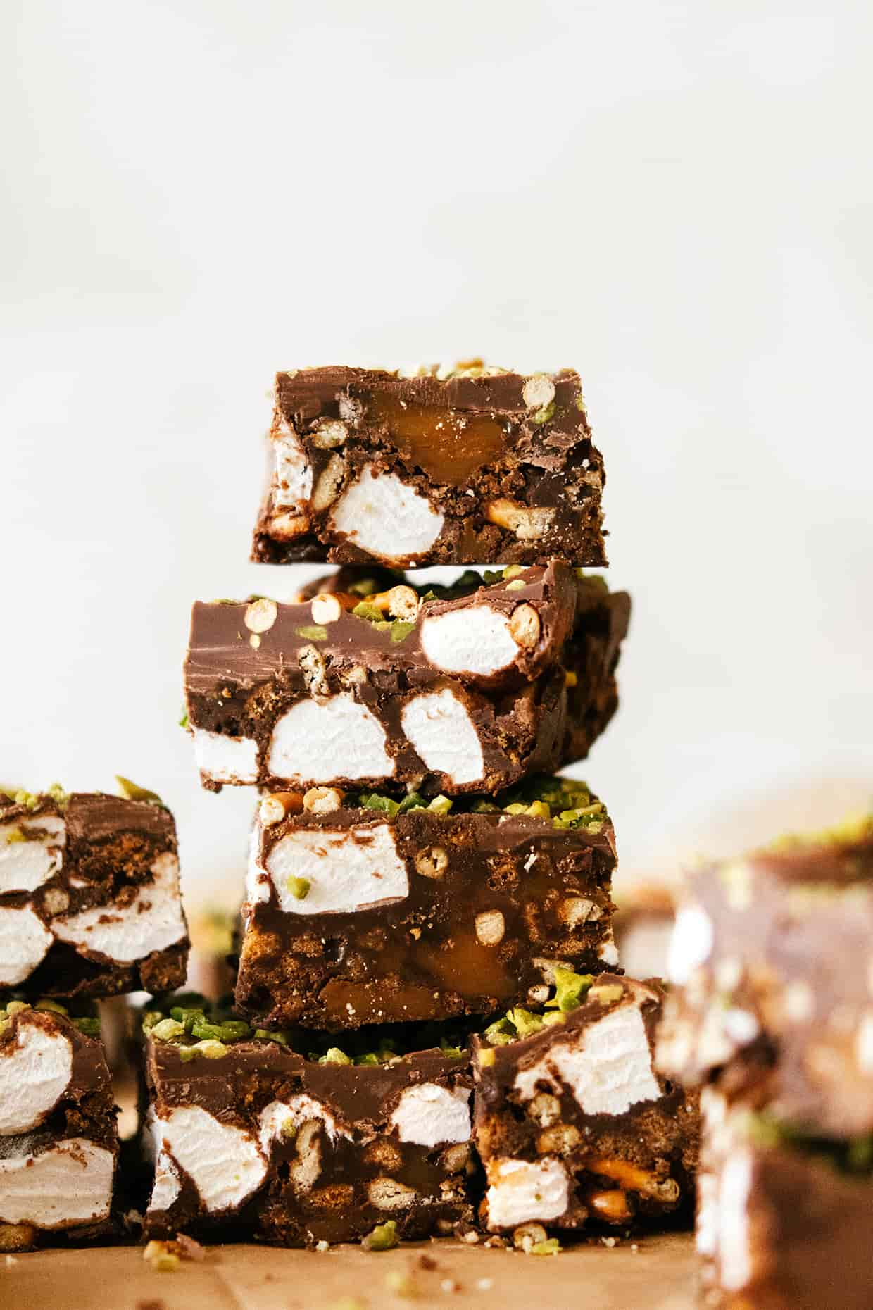 four pieces of chocolate and marshmallow bars stacked on top of each other