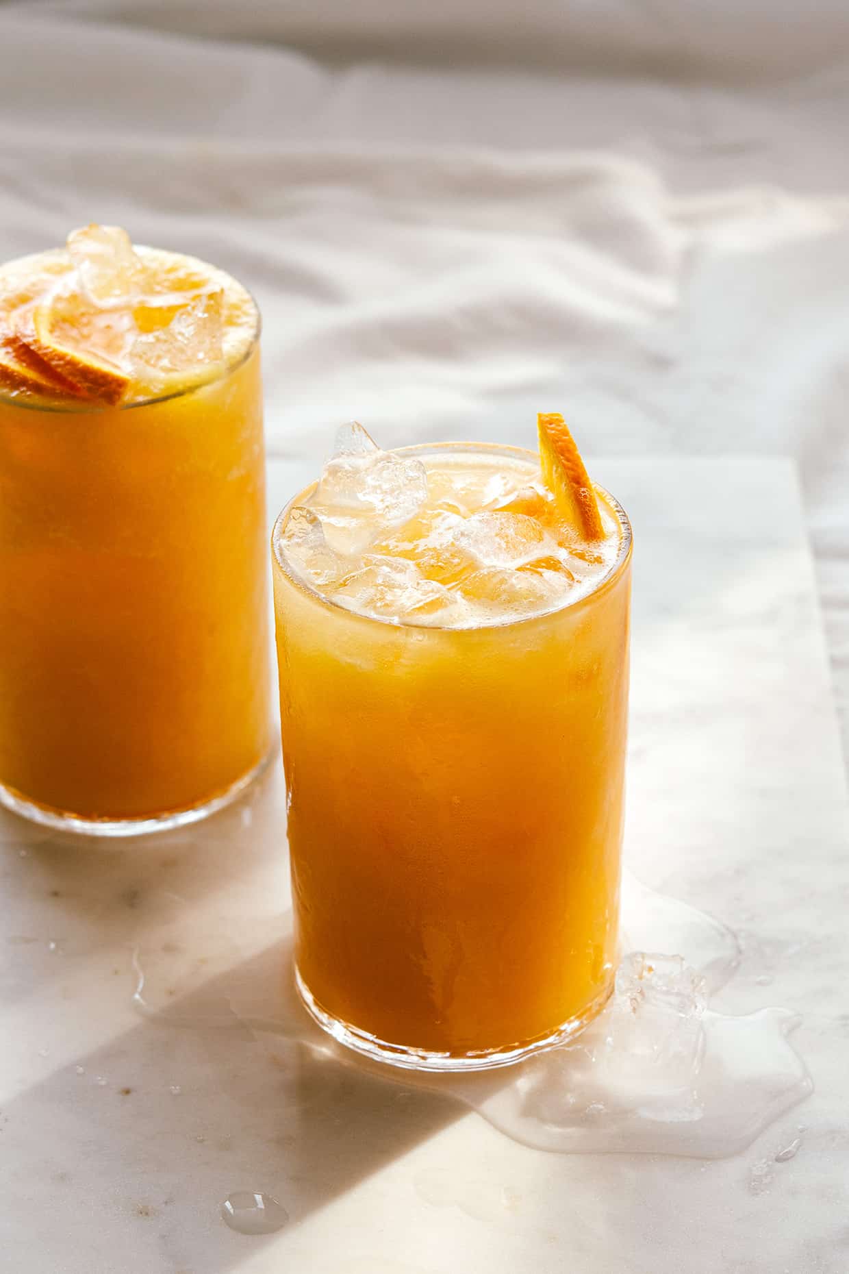 carrot pineapple orange coolers served on marble board