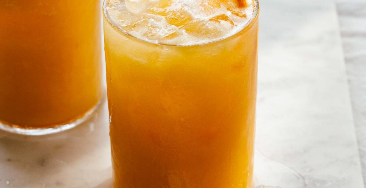 close view of carrot pineapple orange juice served over ice