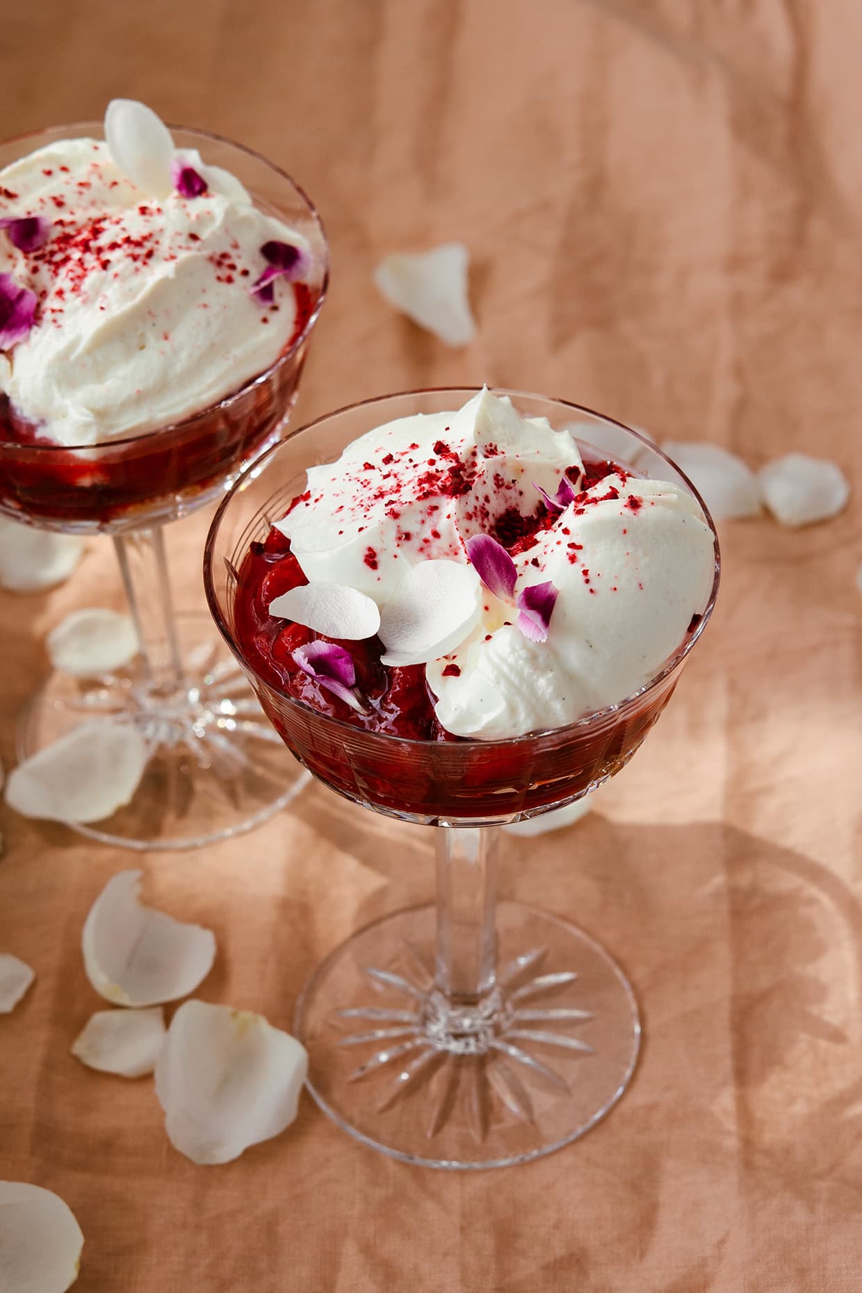 glasses filled with strawberry sauce and whipped cream frosting