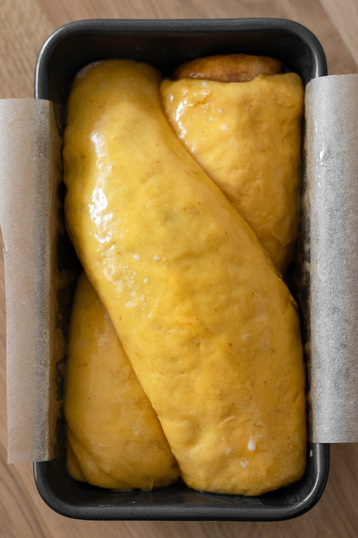buttered brioche bread in loaf pan