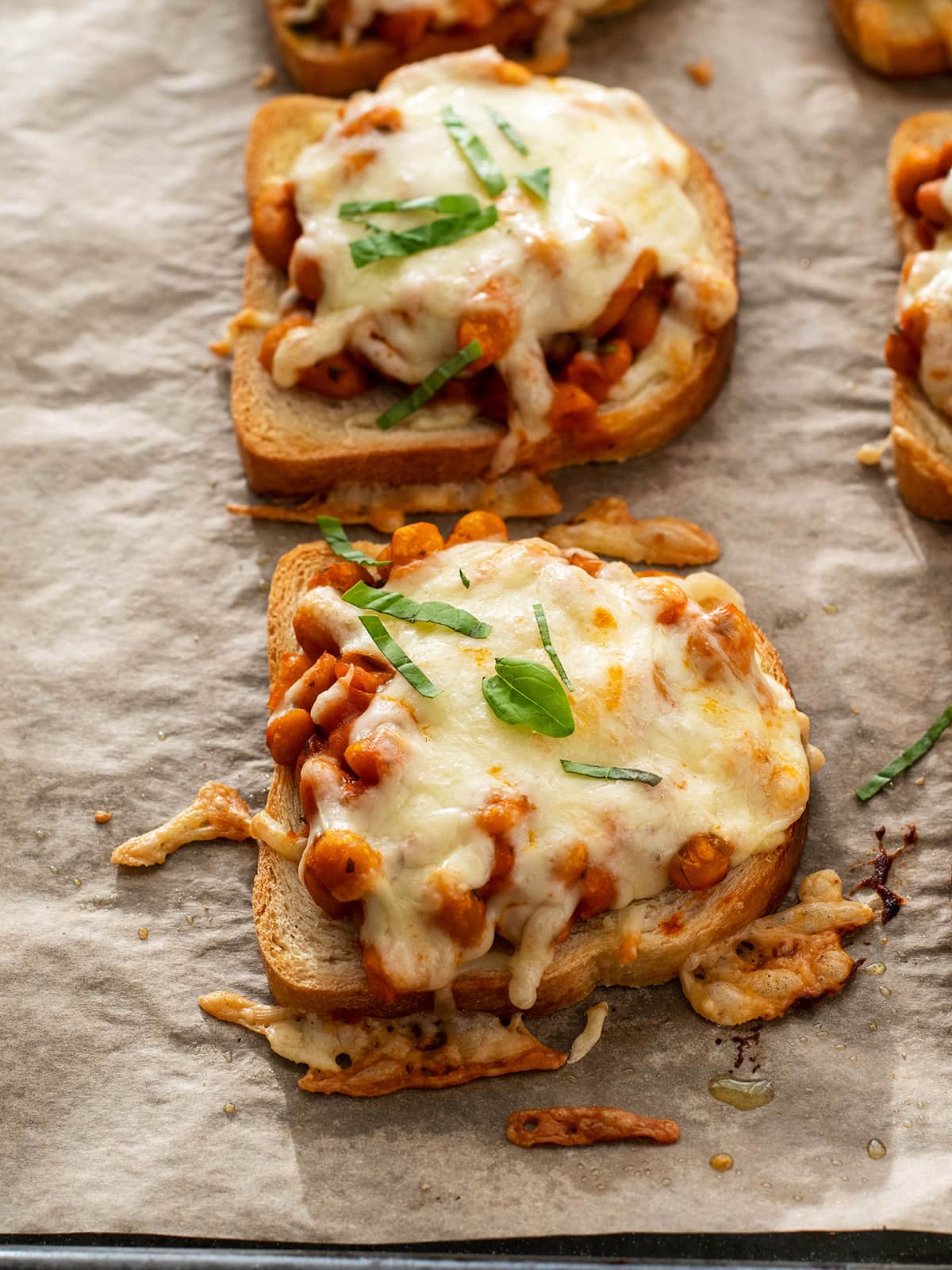 pizza beans with cheese on toast on baking sheet