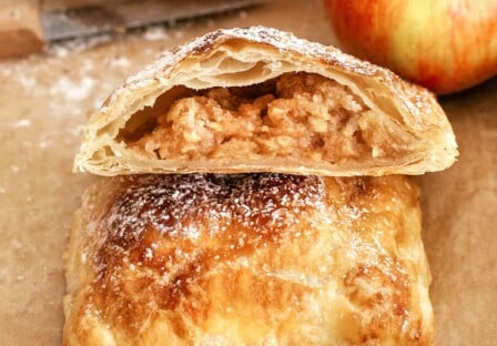 close view of sliced apple pie with puff pastry