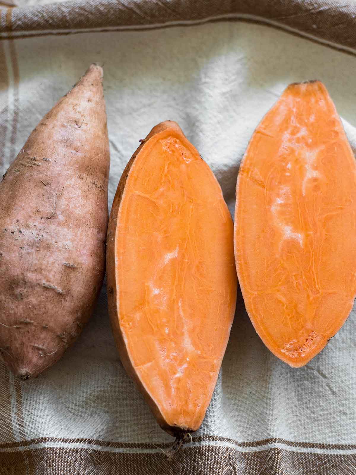 raw orange sweet potato sliced in half