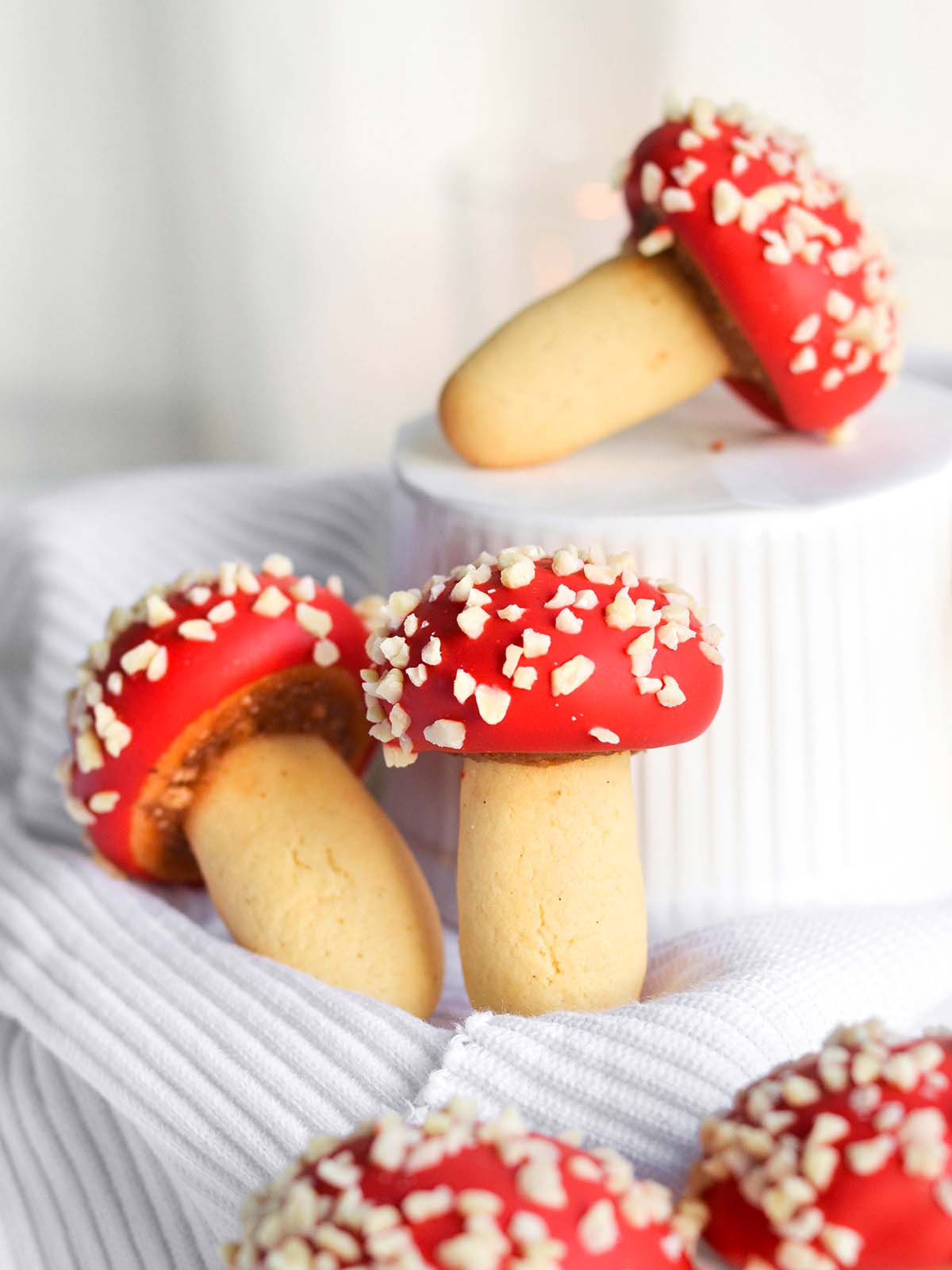 red mushroom shaped cookies with a strawberry almond filling