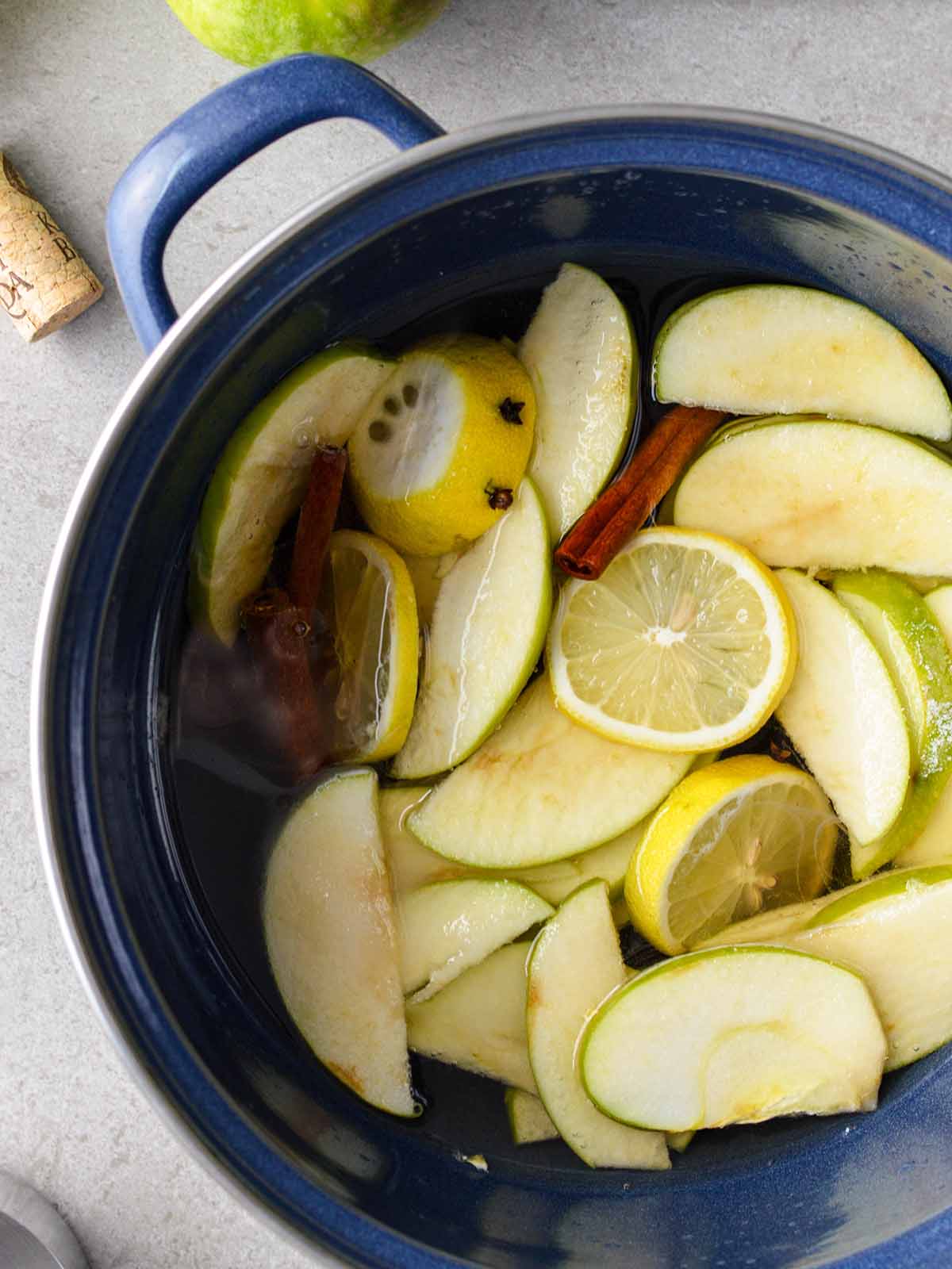 apples and lemons mixed with wine in a pot