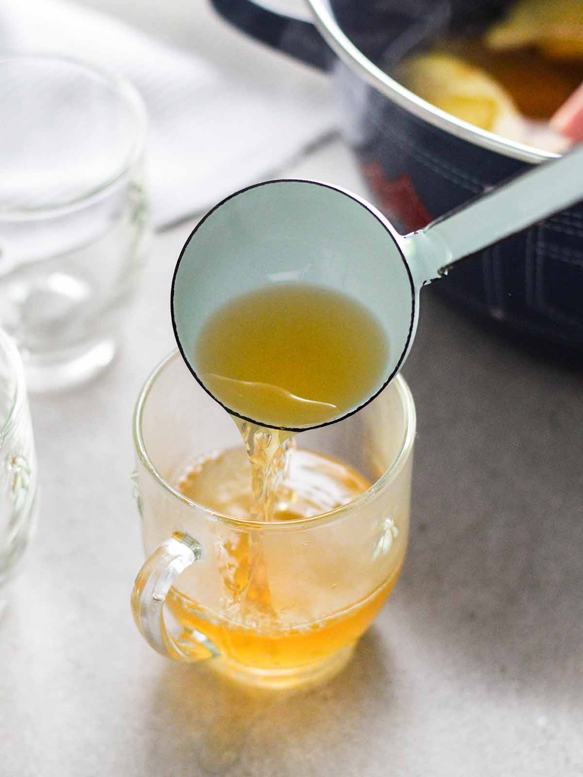 serving mulled wine with a ladle 