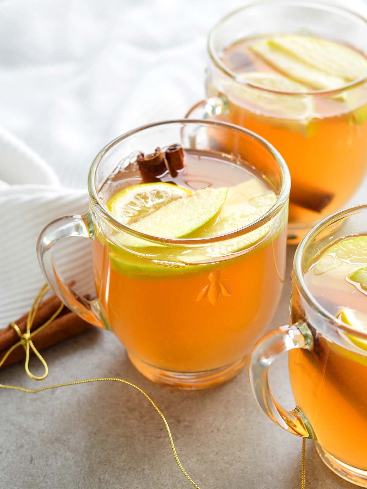 mulled wine with sliced apples and lemons in glasses
