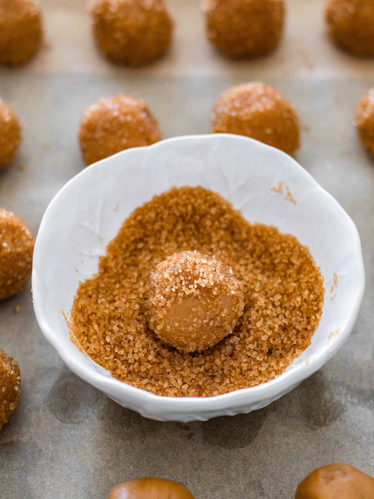 rolling peanut cookie ball in sugar