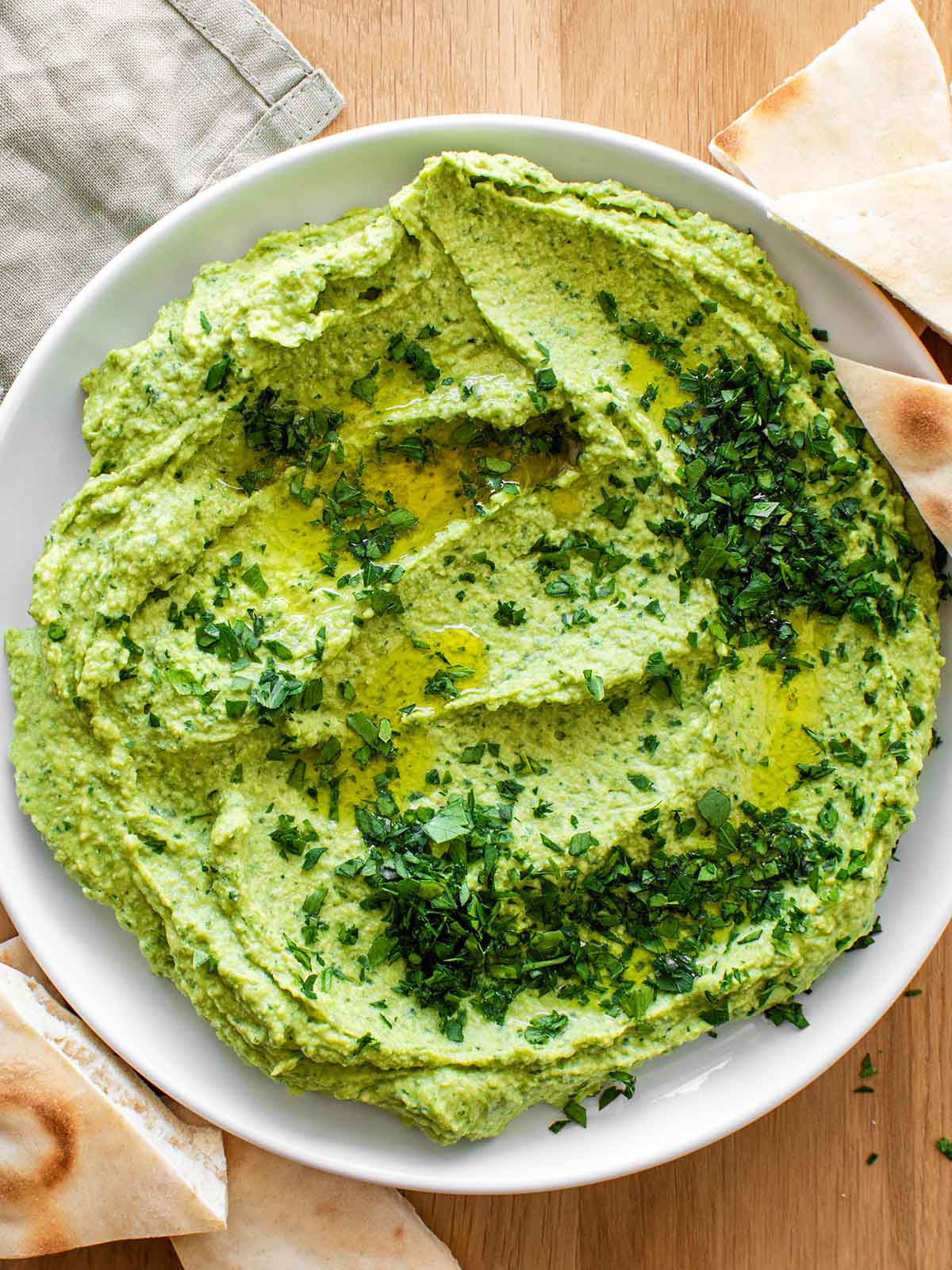parsley hummus spread with olive oil and pita bread